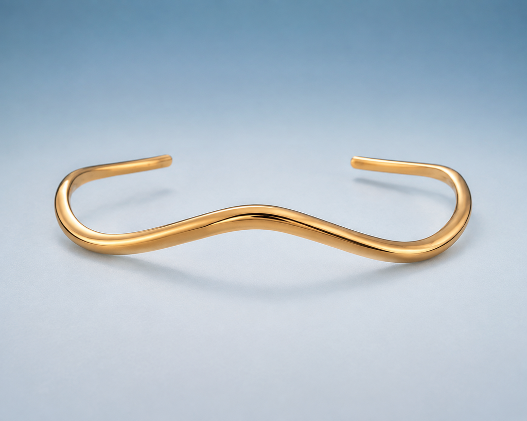 FLUID Cuff in gold — sculptural wave open cuff, studio view