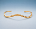 FLUID Cuff in gold — sculptural wave open cuff, studio view