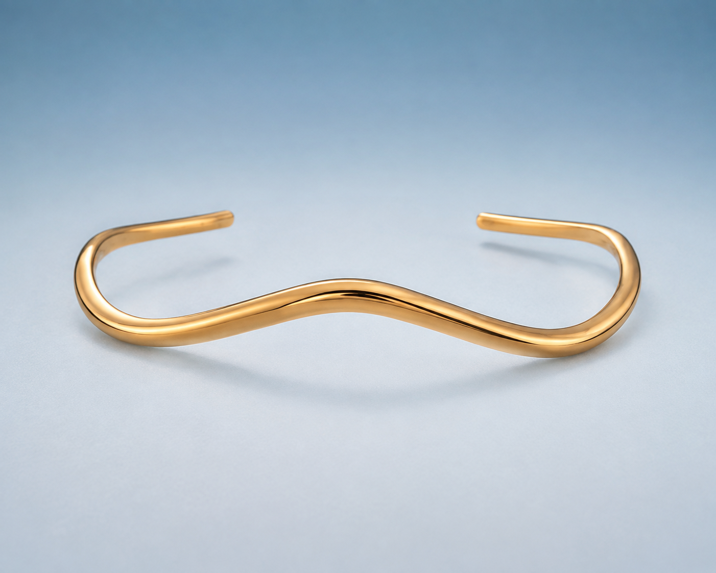 FLUID Cuff in gold — sculptural wave open cuff, studio view