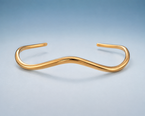 FLUID Cuff in gold — sculptural wave open cuff, studio view
