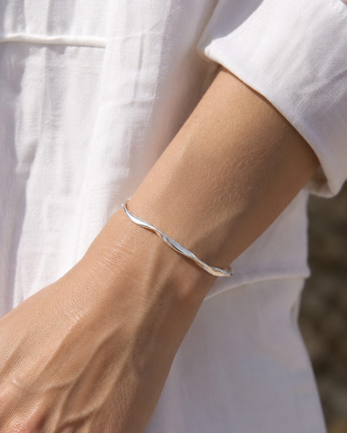 VEER Cuff in silver worn on wrist in natural daylight