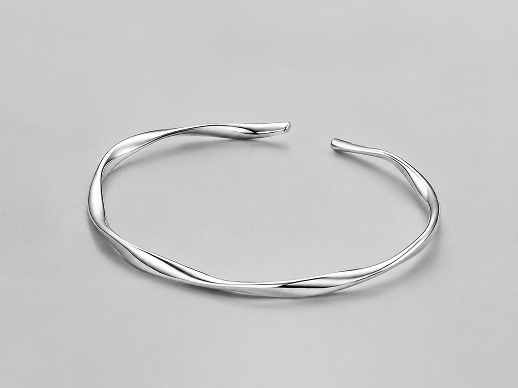 VEER Cuff in silver — sculptural twisted open cuff, studio view