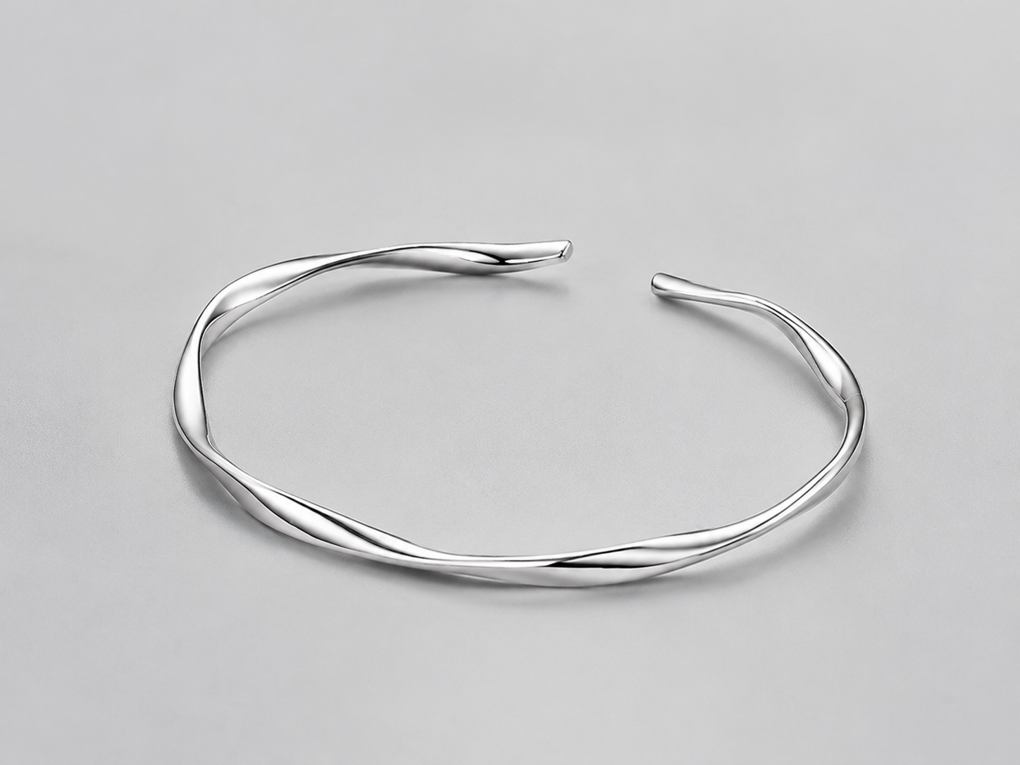 VEER Cuff in silver — sculptural twisted open cuff, studio view