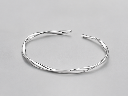 VEER Cuff in silver — sculptural twisted open cuff, studio view